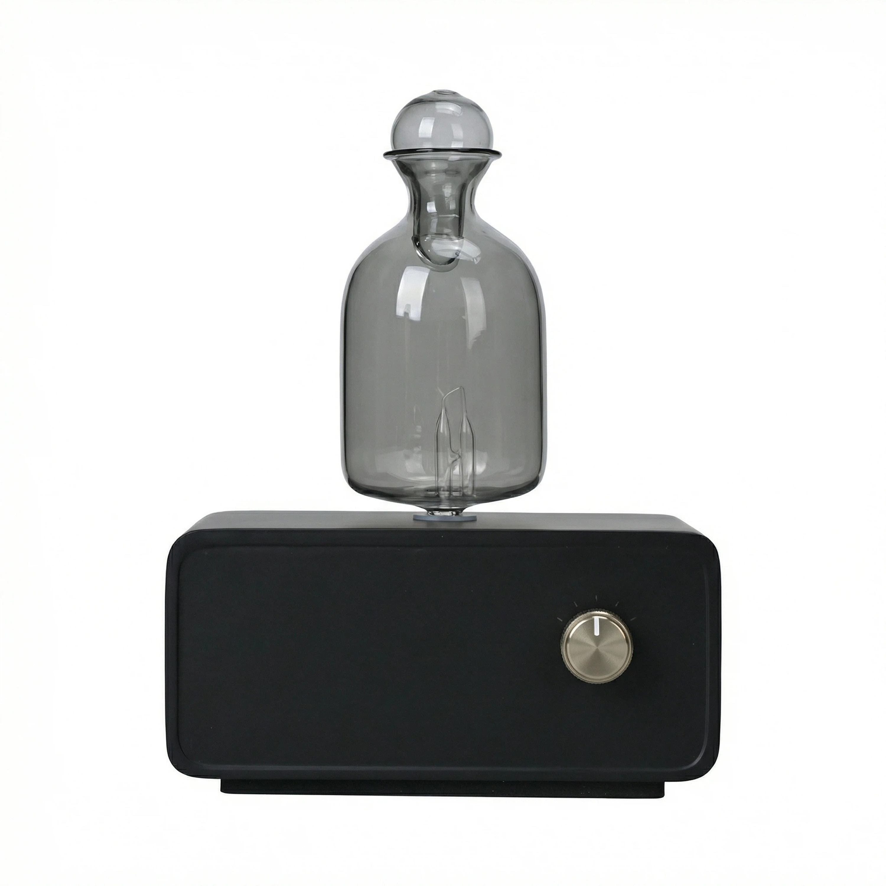 Black magnetic levitation device with a clear glass bulb on a white background